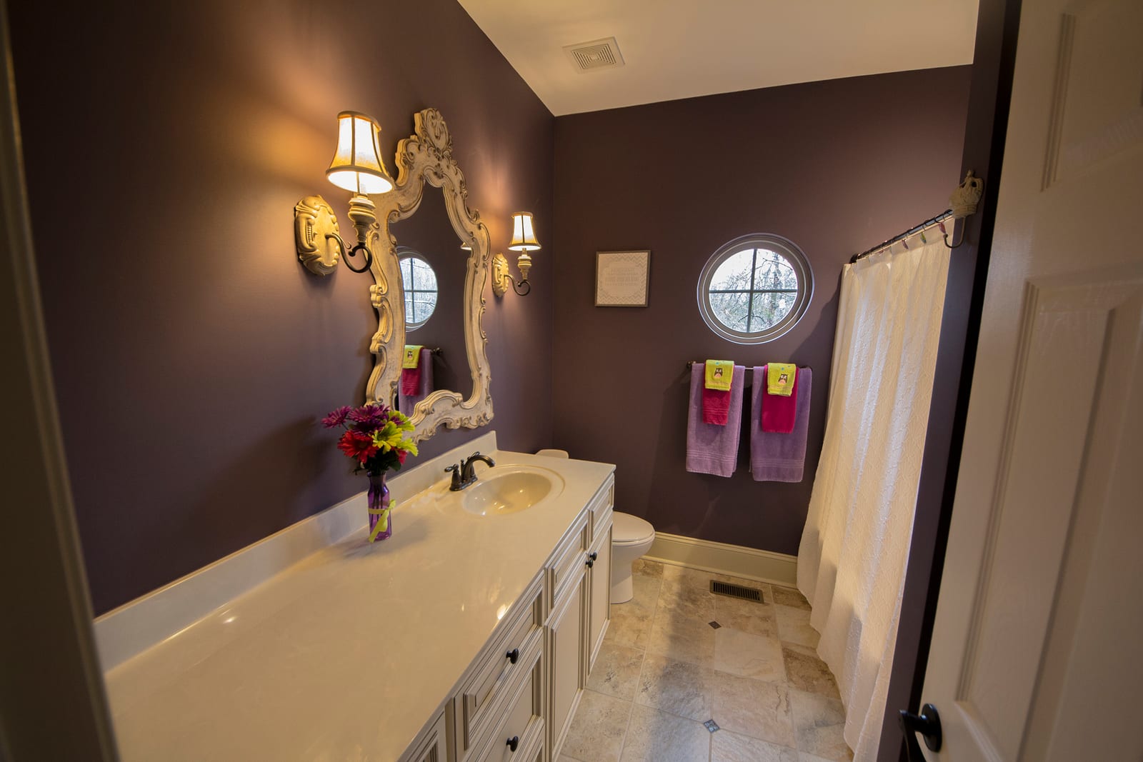 Bathroom design with custom vanity and round window