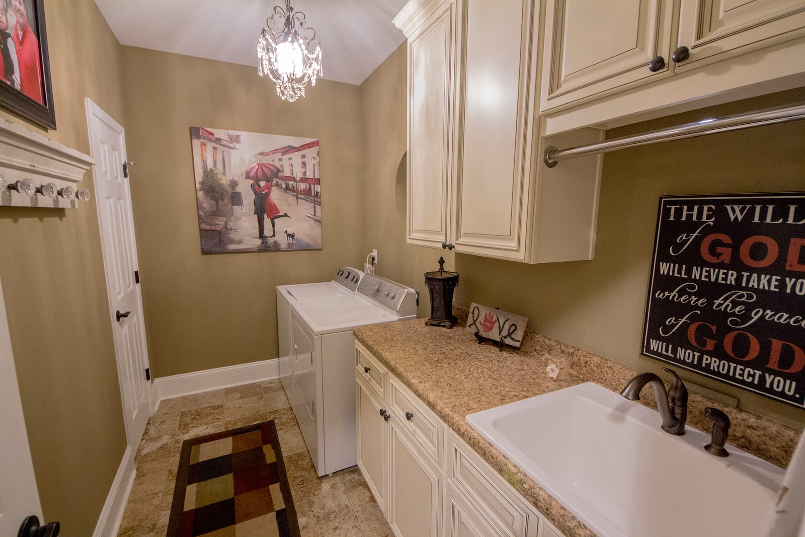 Laundry room design with custom cabinetry and utility sink