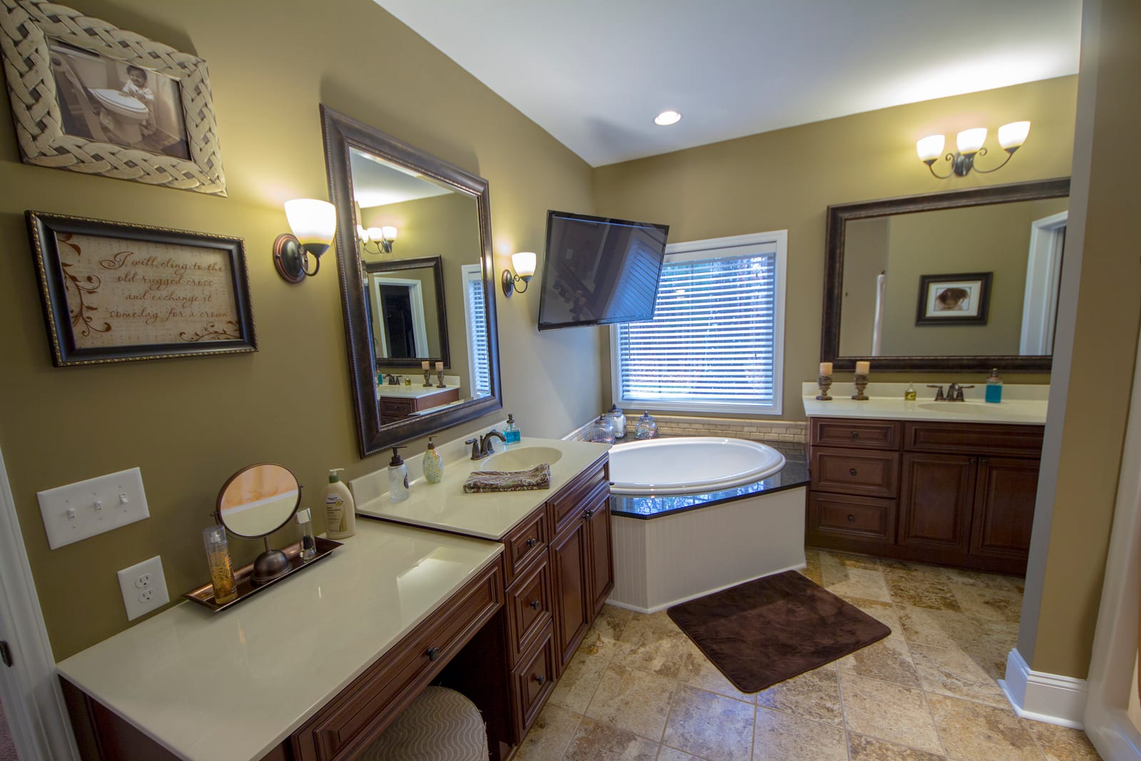 Primary bathroom design with dual vanities and corner tub
